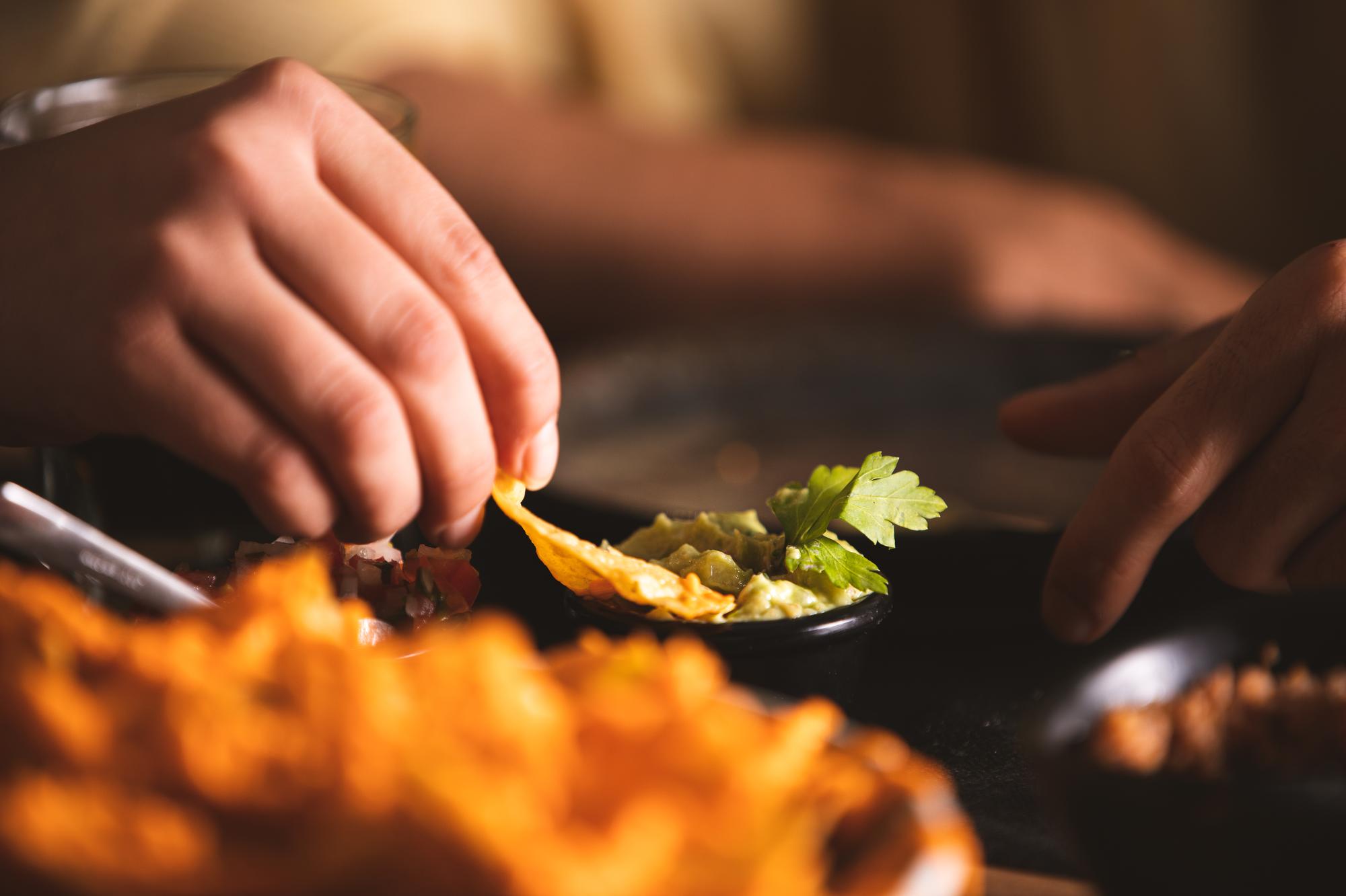 Chef arranging a plated dish in a warm kitchen