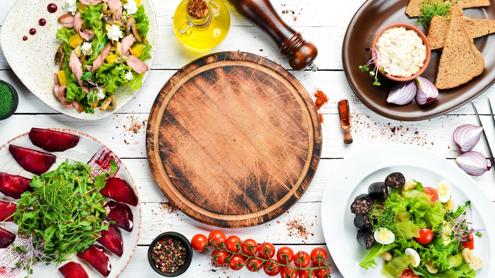 Assorted plated dishes arranged on wooden board